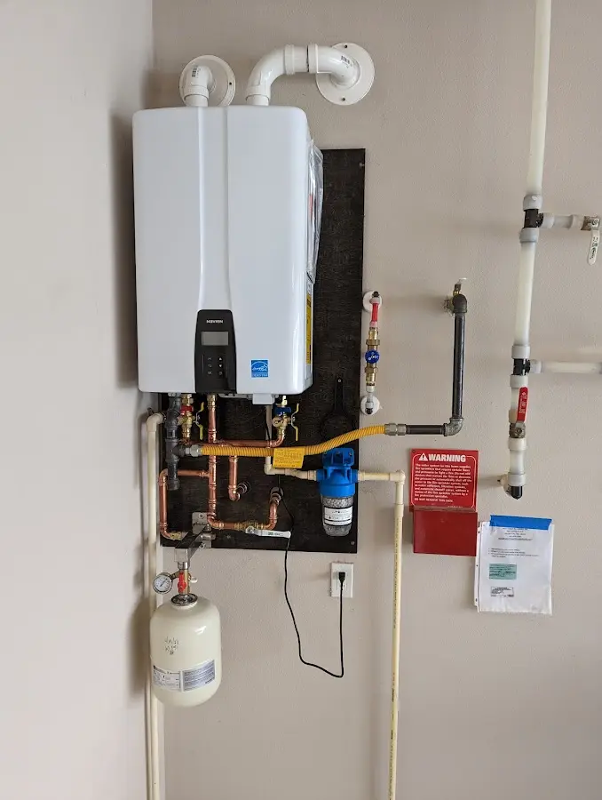 Professional plumber installing copper piping in a Del Monte Forest home